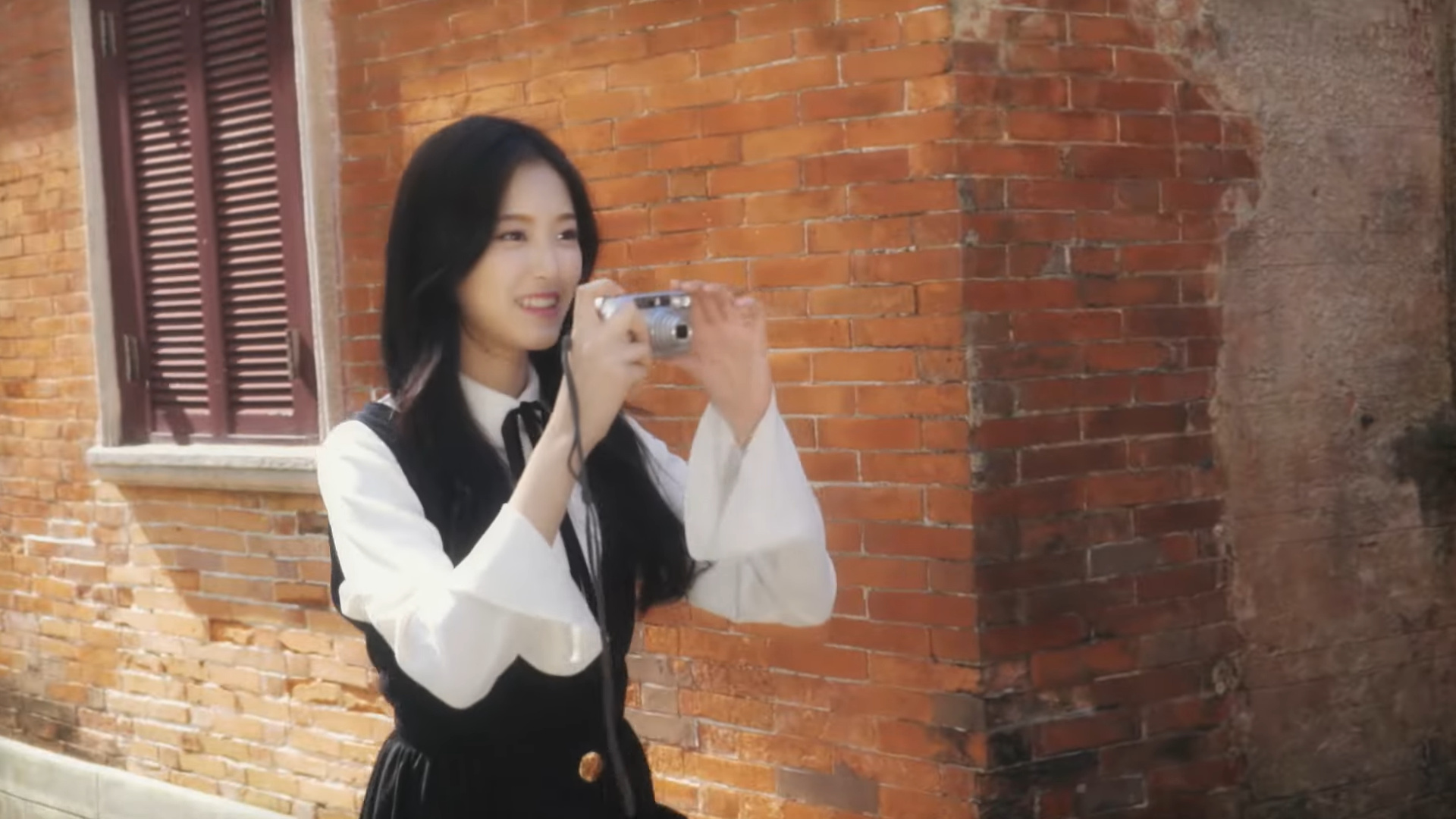 Hyunjin holding a camera.